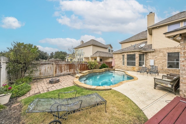 view of swimming pool with a yard, a patio area, and an outdoor fire pit