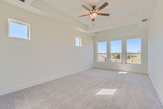 carpeted empty room featuring ceiling fan and a wealth of natural light