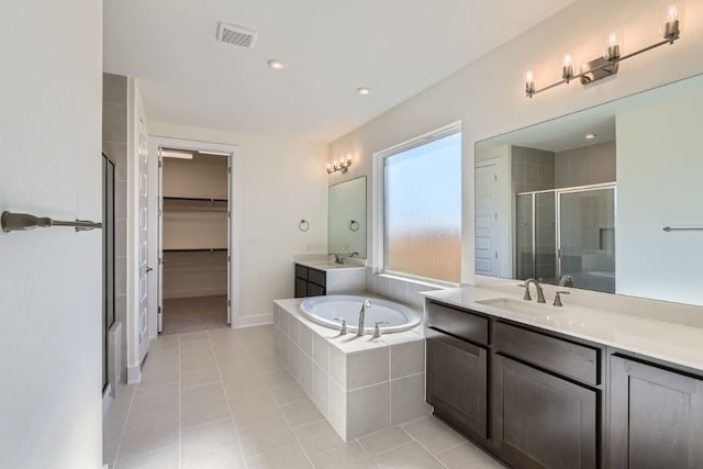 bathroom with tile patterned floors, vanity, and separate shower and tub