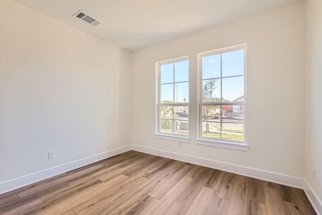 unfurnished room with light hardwood / wood-style flooring