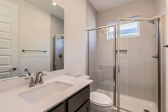 bathroom with vanity, toilet, and walk in shower