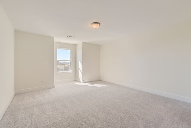 empty room with light colored carpet