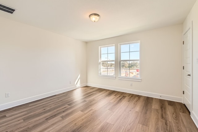 unfurnished room featuring hardwood / wood-style flooring