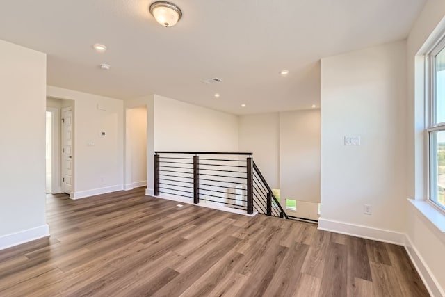 empty room with hardwood / wood-style flooring