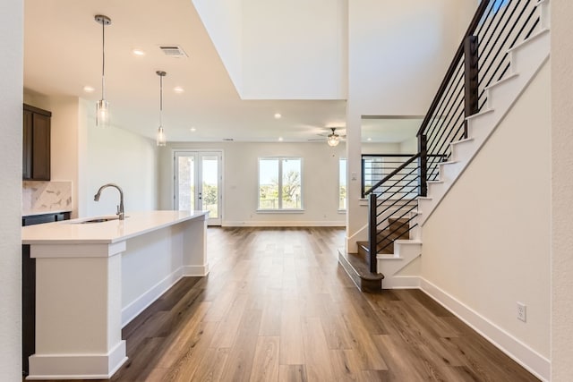 entryway with french doors, dark hardwood / wood-style floors, ceiling fan, and sink