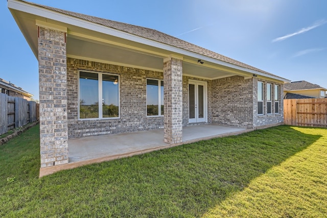 back of house featuring a patio area and a yard