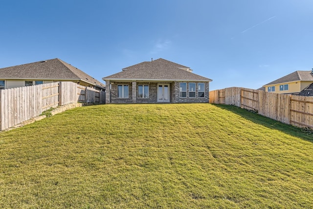 back of house featuring a yard