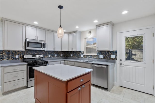 kitchen with white cabinets, decorative backsplash, decorative light fixtures, and appliances with stainless steel finishes