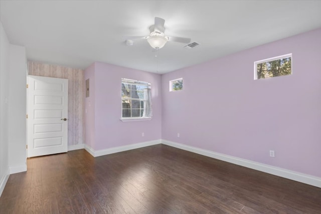 unfurnished room featuring dark wood-type flooring, a wealth of natural light, and ceiling fan