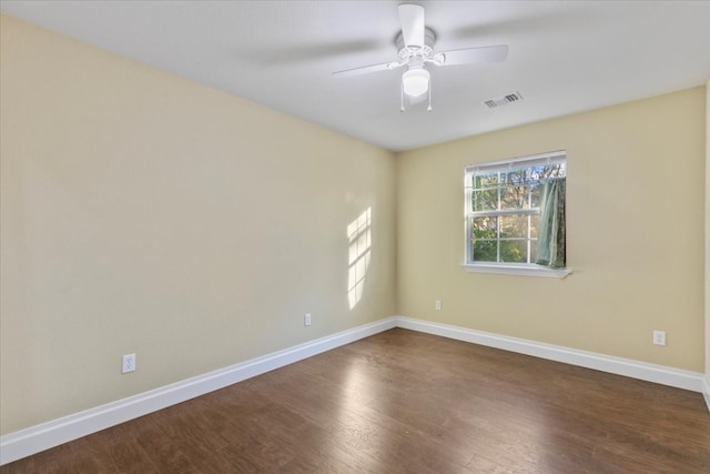 spare room featuring ceiling fan and dark hardwood / wood-style floors