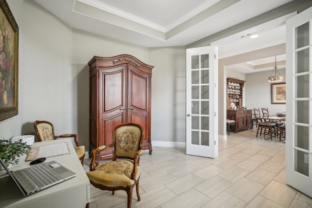 living area with crown molding, a raised ceiling, and french doors