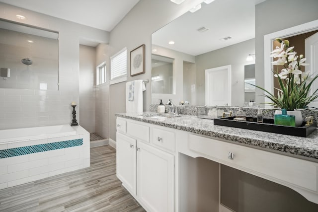 bathroom with wood-type flooring, vanity, and separate shower and tub