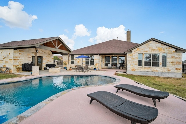 view of pool with a grill, ceiling fan, and a patio