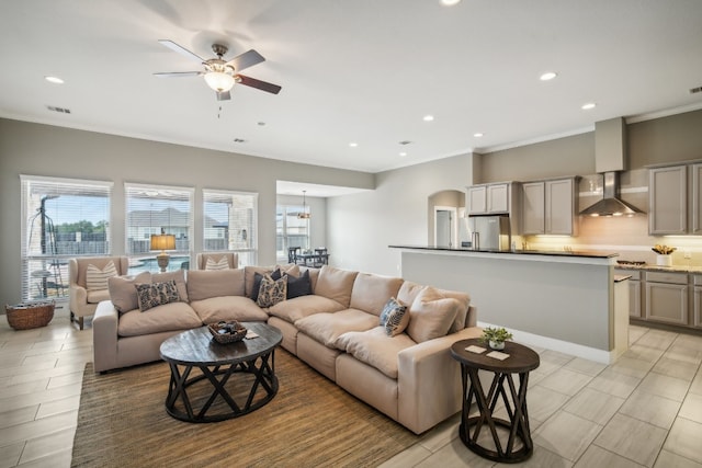 living room featuring ornamental molding and ceiling fan