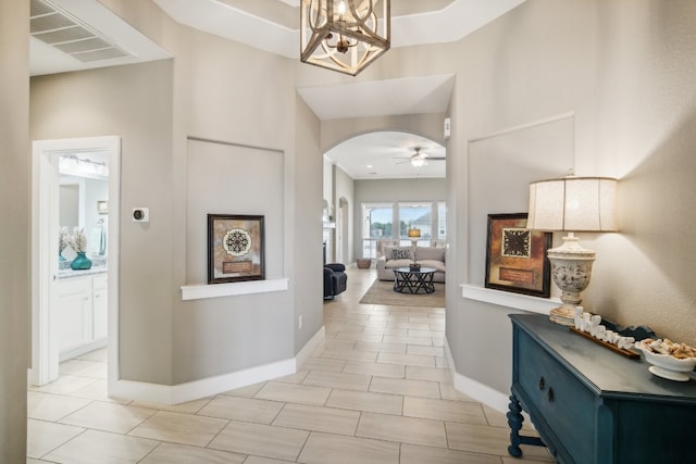 hallway featuring a high ceiling