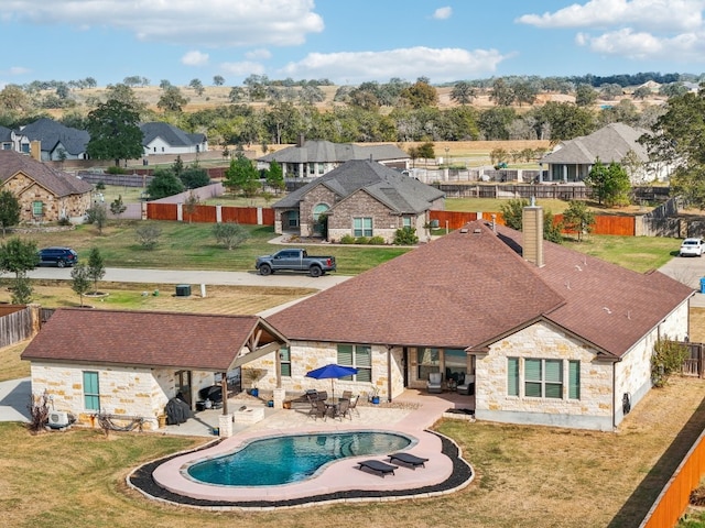 view of swimming pool with a yard and a patio area