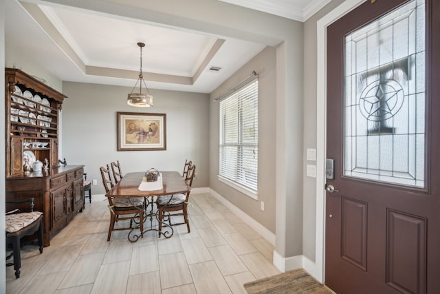 dining room featuring crown molding and a tray ceiling