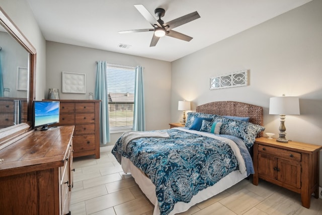 tiled bedroom featuring ceiling fan