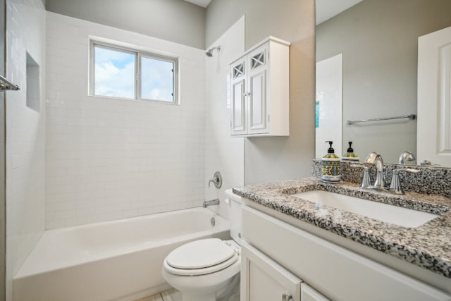 full bathroom featuring vanity, toilet, and tiled shower / bath