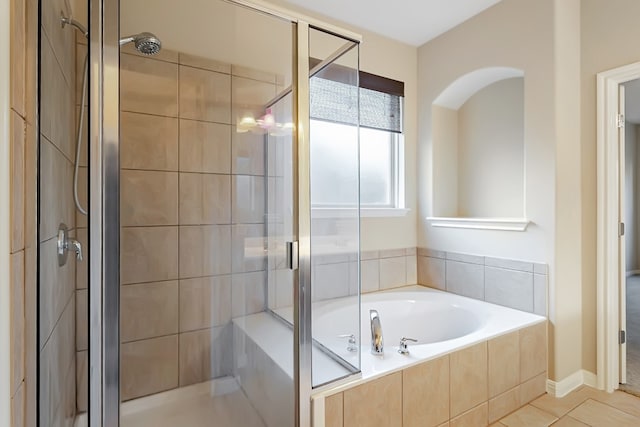 full bath with tile patterned flooring, a shower stall, and a bath