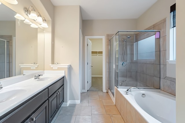 bathroom featuring a stall shower, tile patterned flooring, a sink, and a spacious closet