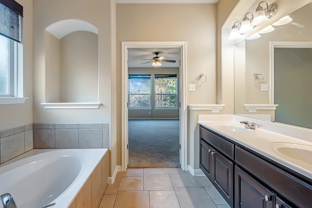 full bath with double vanity, a garden tub, a sink, and tile patterned floors