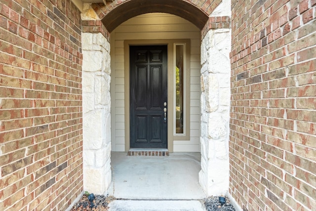 property entrance with brick siding