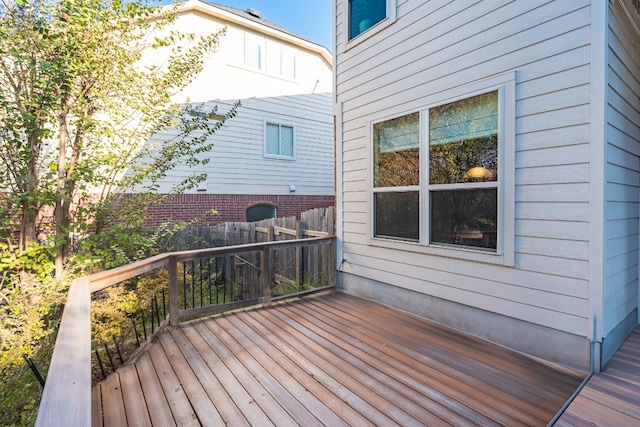 wooden terrace featuring fence