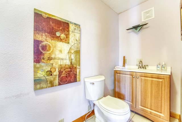 bathroom with vanity, tile patterned flooring, and toilet