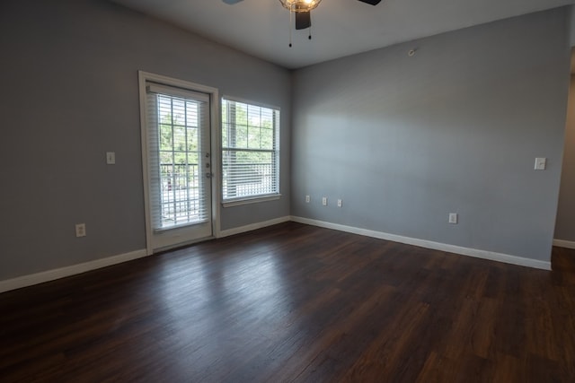 empty room with ceiling fan and dark hardwood / wood-style floors