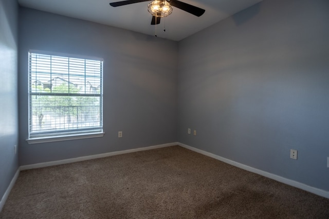 carpeted empty room featuring ceiling fan