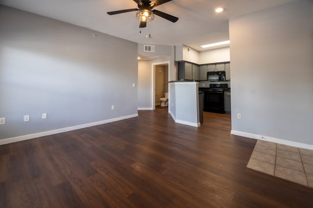 unfurnished living room featuring dark hardwood / wood-style flooring and ceiling fan