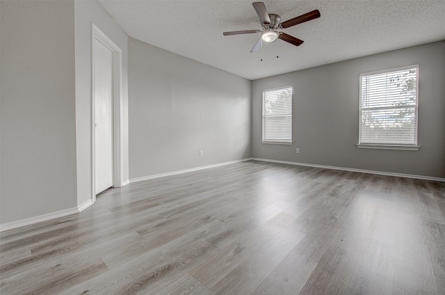 unfurnished room featuring light hardwood / wood-style floors, ceiling fan, and a textured ceiling