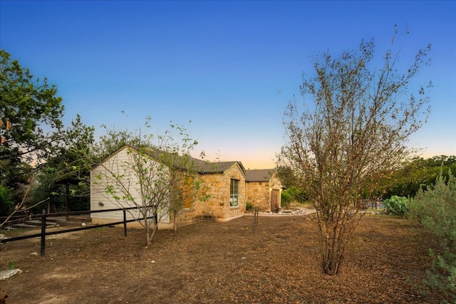 view of back house at dusk