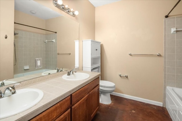 bathroom with a sink, toilet, and baseboards