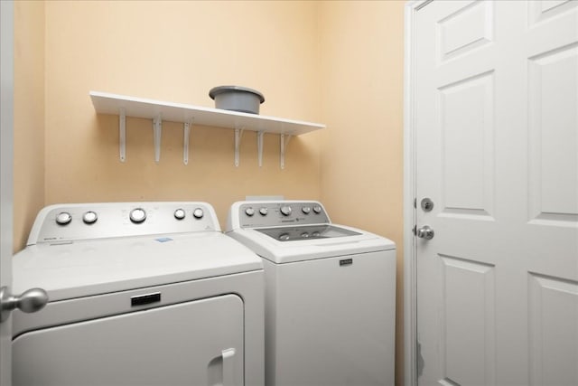 washroom with laundry area and washer and dryer