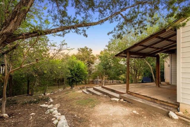 yard at dusk with a wooden deck