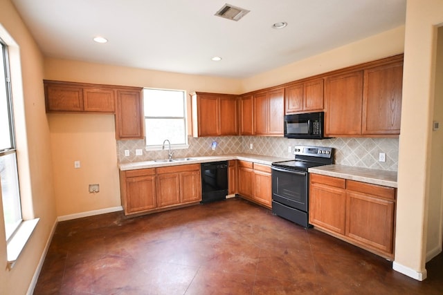 kitchen featuring a sink, visible vents, backsplash, brown cabinets, and black appliances