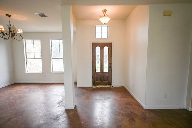 entrance foyer with a chandelier, visible vents, and baseboards