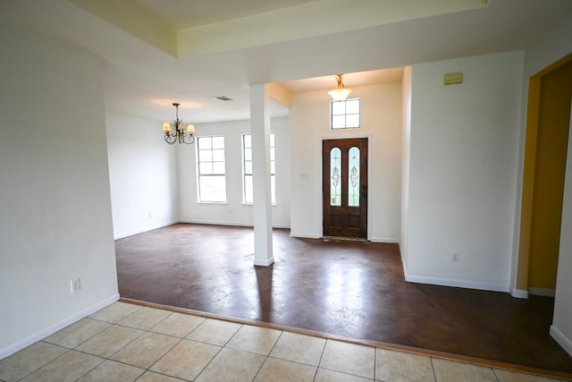 entryway with visible vents, a notable chandelier, baseboards, and light tile patterned floors