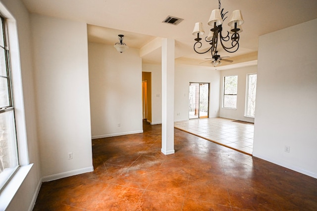 interior space with a chandelier, visible vents, and baseboards