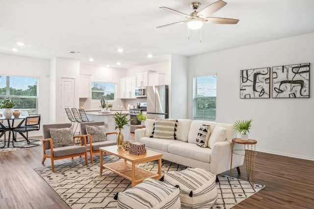 living room with hardwood / wood-style flooring, plenty of natural light, and ceiling fan