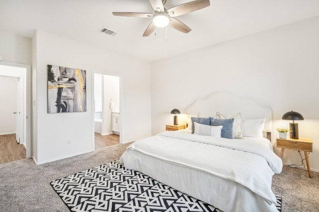 bedroom with carpet flooring, ensuite bath, and ceiling fan