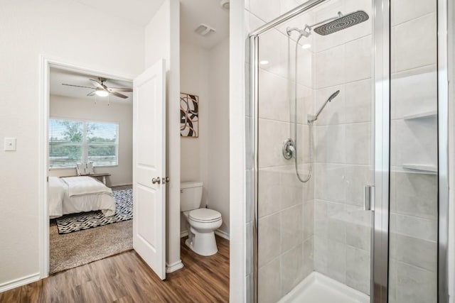 bathroom with walk in shower, ceiling fan, hardwood / wood-style floors, and toilet