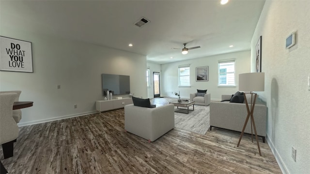 living room featuring hardwood / wood-style flooring and ceiling fan