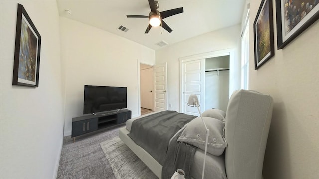 bedroom with a closet, ceiling fan, and light colored carpet