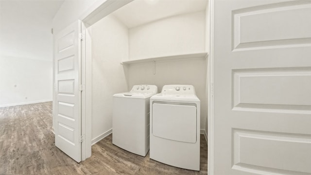 washroom featuring independent washer and dryer and hardwood / wood-style flooring