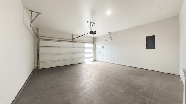 garage with a garage door opener and electric panel