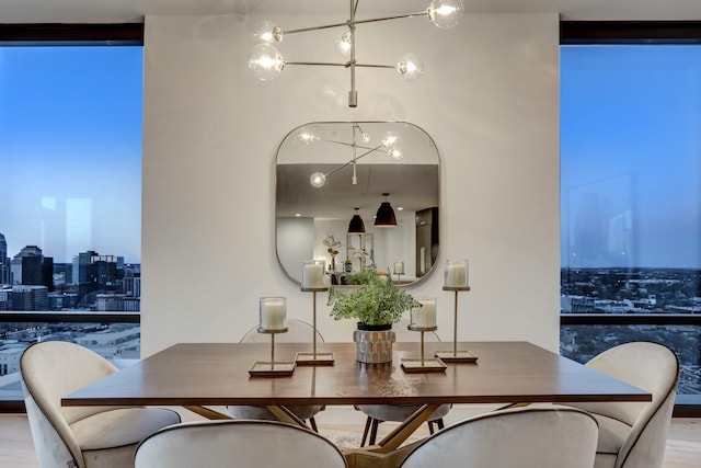 dining space featuring a chandelier, floor to ceiling windows, and hardwood / wood-style flooring