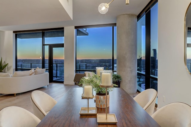 dining room featuring a wall of windows and hardwood / wood-style floors